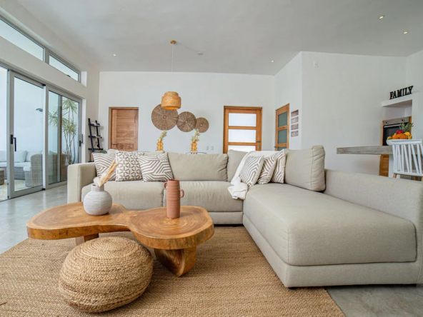 bright living room with l-shaped sofa, wood coffee table, boho decor