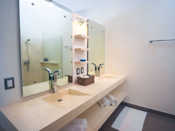 modern bathroom with double stone sink vanity and wall mirrors